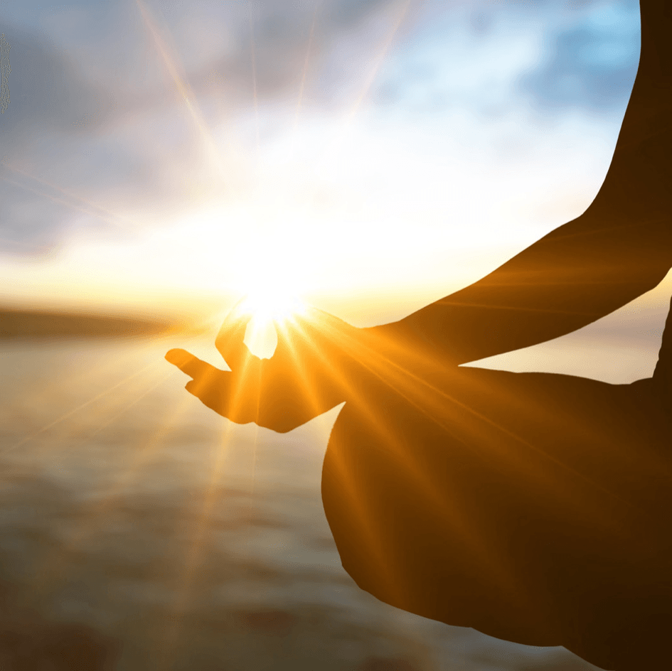 Person meditating on the beach